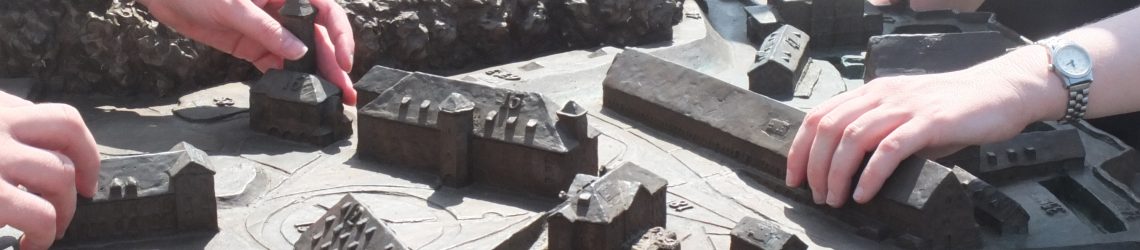 Some hands are exploring the tactile model of Koenigstein Fortress in the Saxonian Swiss